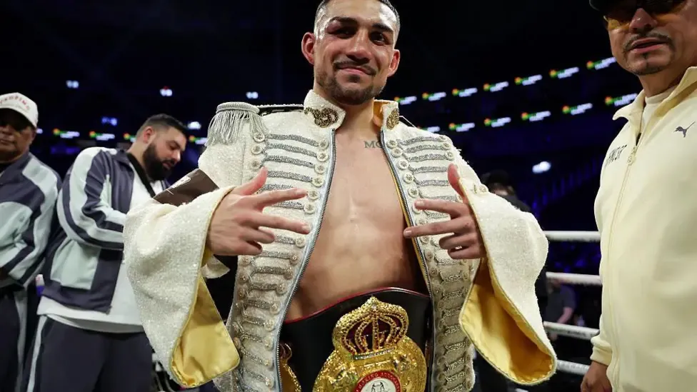 Teofimo Lopez celebrates with his world title aroud his waist