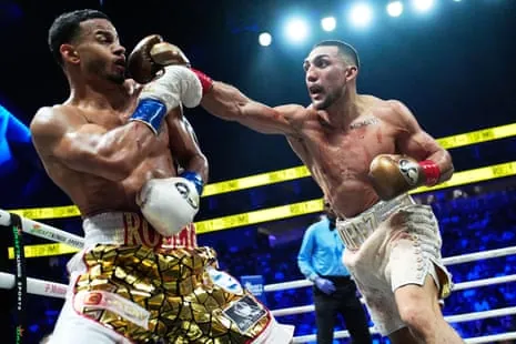 Rolando Romero (left) tries to evade a punch from Teófimo López on Saturday night in Las Vegas.