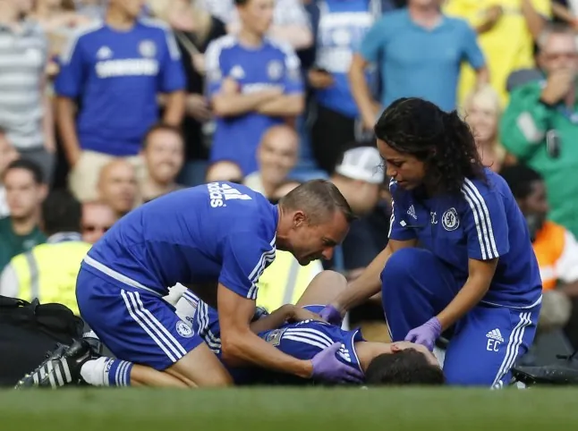 Chelsea doctor Eva Carneiro and head physio Jon Fearn treat Chelsea's Belgian midfielder Eden Hazard late on during the English Premier League football match between Chelsea and Swansea City at Stamford Bridge in London, England. Chelsea have sidelined team doctor Eva Carneiro from match-day duties after she fell foul of manager Jose Mourinho, according to British media reports on August 11, 2015. Mourinho criticised Carneiro after she ran on the pitch to treat Eden Hazard in stoppage time of Chelsea's 2-2 draw at home to Swansea City on August 8, saying she did not "understand the game". AFP PHOTO / IAN KINGTON RESTRICTED TO EDITORIAL USE. No use with unauthorized audio, video, data, fixture lists, club/league logos or 'live' services. Online in-match use limited to 75 images, no video emulation. No use in betting, games or single club/league/player publications. (Photo credit should read IAN KINGTON/AFP/Getty Images)