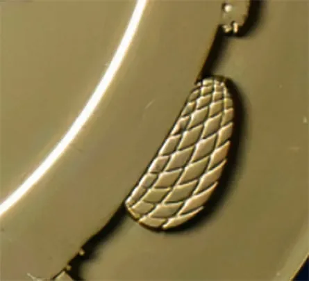Detail of edge of medal showing birds nest like stadium