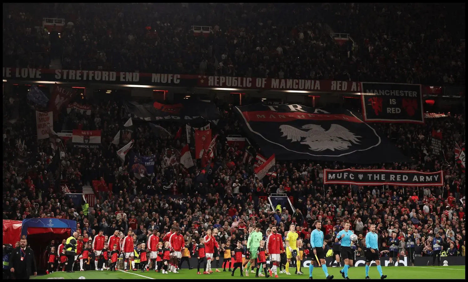 MANCHESTER, ENGLAND - SEPTEMBER 10: A general view as Referee Willy Delajod leads the teams out alongside Assistant Referees Erwan Finjean and Valentin Evrard as fans of Manchester United display banners in support of their team before the UEFA Champions League 2026/27 League Phase MD1 match between Manchester United and Sabah FC at Old Trafford on September 10, 2026 in Manchester, England.