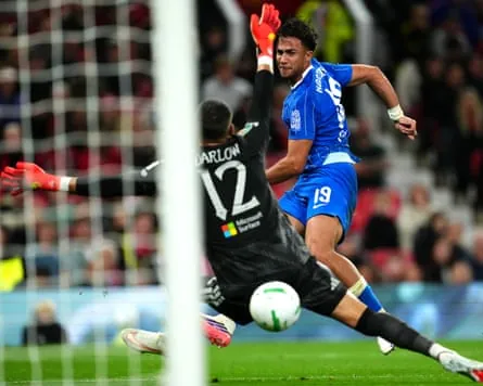 The Brighton striker Charalampos Kostoulas shoots past the Manchester United goalkeeper Karl Darlow to score his team’s first goal in their 3-2 win in the Carabao Cup third round at Old Trafford.